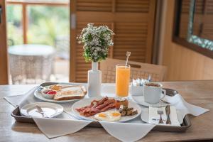 a tray with breakfast foods and a drink on a table at Henann Regency Resort and Spa in Boracay