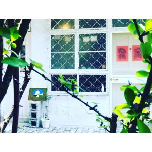 a window of a house with a bird on it at 可以住Canlive in Tainan