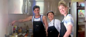 un grupo de tres personas de pie en una cocina en Puri Dajuma Beach Eco-Resort & Spa en Pulukan