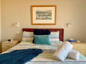 a bedroom with a bed with two pillows on it at Adina Vineyard in Lovedale