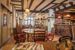 a restaurant with tables and chairs and a bar at Alte Weinstube Burg Eltz in Treis-Karden