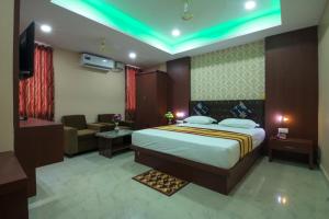 a bedroom with a bed and a living room at CITY VIEW in Port Blair