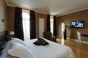 a bedroom with a bed and a tv on the wall at Chateau Du Mont Joly in Sampans