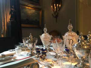 a table with glasses and other items on it at Bourgogne Suite Maastricht in Maastricht
