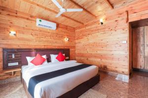 a bedroom with a bed in a wooden room at Bliss Water Resort in Arambol