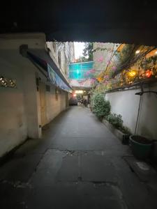 an empty alley way with a tunnel in a building at jojoroom in Ho Chi Minh City