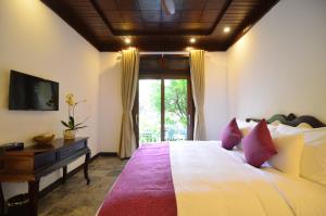 Voodi või voodid majutusasutuse Hoian Central Hotel toas