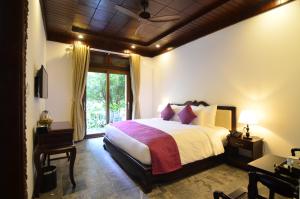 Voodi või voodid majutusasutuse Hoian Central Hotel toas