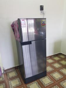 a refrigerator in the corner of a room at Homestay Che Wan in Kuantan