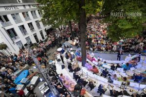 a large crowd of people watching a show in a street at Derlon Hotel Maastricht in Maastricht