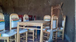 a wooden table and chairs in a room at Bethan Amba ecovillage in Lalibela