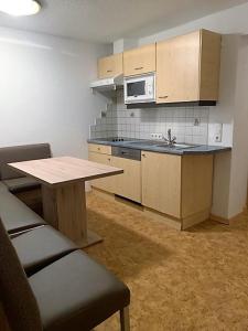 a kitchen with a table and a counter top at Lärchenheim Apartments in Ischgl