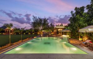 a swimming pool in a backyard with a house at Tree of Life Inderpura Resort, Jhunjhunu in Jhunjhunūn