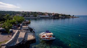 a boat is docked in a large body of water at Apartments Luci and Kety in Lun