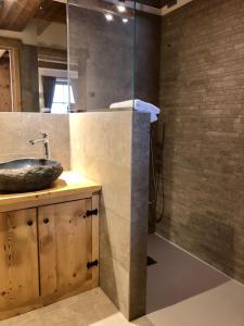 a bathroom with a sink and a shower at Ciasa Coletin in Alvera