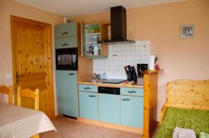 a kitchen with a blue refrigerator and a stove at Gîte de La Belle Étoile in Mercury