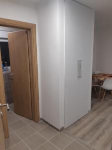 a white cabinet in a room with a door at Snowman Studio Apartment Jahorina in Jahorina