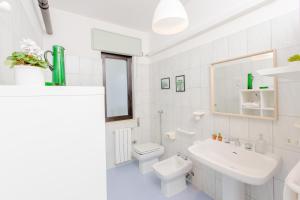 a white bathroom with a toilet and a sink at La Terrazza di Marco in Torre Santa Sabina +39 photos