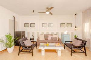 a living room with a couch and a table and chairs at La Terrazza di Marco in Torre Santa Sabina