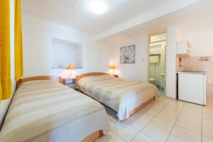 Posteľ alebo postele v izbe v ubytovaní Villa Carmen Rooms & Apartments