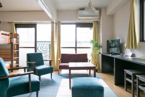 a living room with chairs and a table at Nishi Nakasu apartment 301 in Fukuoka