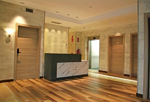 a lobby with wooden floors and wooden doors at Hotel NERU con Encanto in León