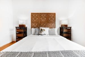 1 dormitorio con 1 cama blanca grande y 2 mesitas de noche en Apartaments El Floc en El Tarter