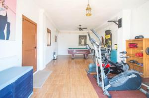 a room with a gym with a exercise bike at Casa Arts guest rooms in Alcaucín