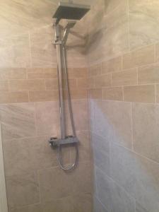 a shower with a shower head in a bathroom at Cauldwell Villas in South Shields