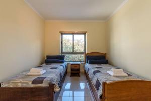Кровать или кровати в номере Deluxe Oceano Azul Apartment