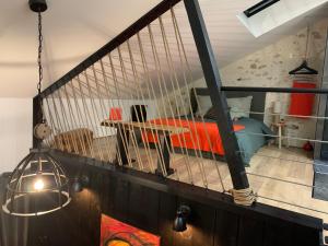 a room with a bed and a hanging light at L'Atelier Planqué in Le Mans