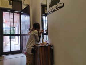 a woman taking a picture of herself in a mirror at Live Free Hostel Rishikesh in Rishīkesh