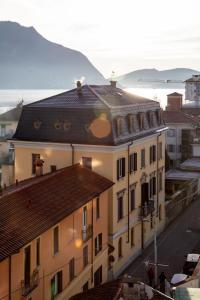 a view of a building with a mountain in the background at Hotel Casa Camilla in Verbania