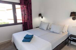 a bedroom with a bed with two towels on it at Villa La Zenia in Orihuela