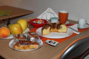 a table topped with a loaf of bread and fruit at i 2 puttini in Catania