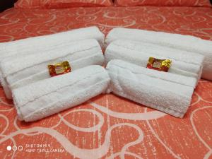 duas toalhas com anéis dourados em cima de uma cama em La dimora di bronzo em Nápoles