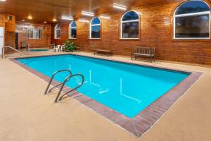 a large swimming pool in a building with a brick wall at Baymont by Wyndham Salida in Salida