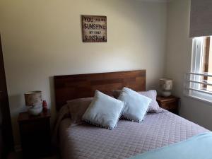 a bedroom with a bed with two white pillows at Plaza Brintrup in Puerto Varas