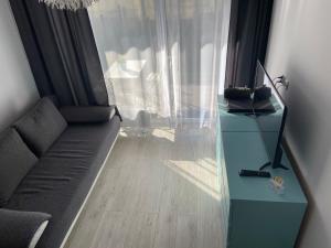 Televízia a/alebo spoločenská miestnosť v ubytovaní Apartamenty Bursztynowe w Kołobrzegu Sun&Relax