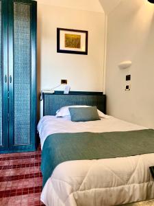 a bedroom with a large bed in a room at Hotel Della Baia in Portovenere