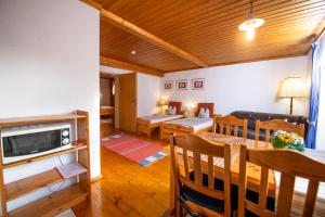 a living room with a couch and a dining room at Ferienwohnungen Am Sonnenhang in Theisseil +5 photos