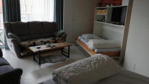 a living room with a dog laying on a couch at Studio Raversijde with Sea View in Ostend