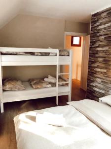 a room with two bunk beds and a bed at Vikendica Rita in Risovac