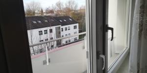 an open window with a view of a building at Apartment Goldberg in Sindelfingen