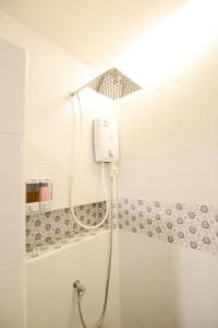 a shower in a bathroom with a shower head at Thaiphiphat house in Bangkok
