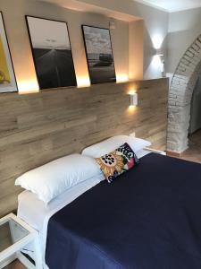a bedroom with a large bed with two pillows at Le Coste Casa Vacanze in Scarlino