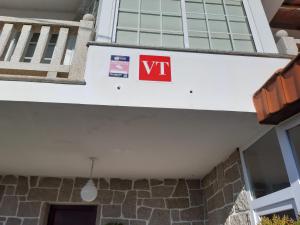 a exit sign on the side of a building at Apartamentos Barrosa in Portonovo