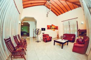 a living room with chairs and a table at The Brtish Independence Inn in Negombo