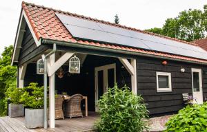 a solar roof on a house with a deck at Bed & Breakfast De Schuur Inn in Numansdorp