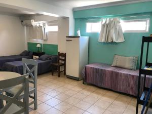 a living room with two beds and a couch at Departamento Belgrano 7 in Salta